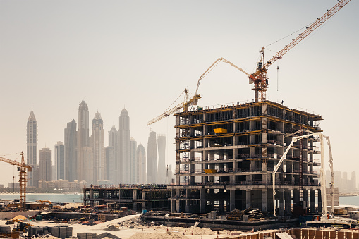New construction work in Dubai. Marina Dubai district in the background.